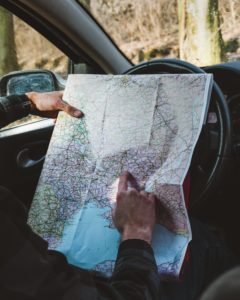 Driver looking at map in car